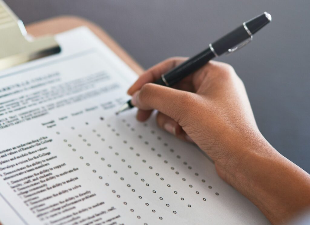 Completing the survey. Cropped shot of an unrecognizable businesswoman filling in a questionnaire.